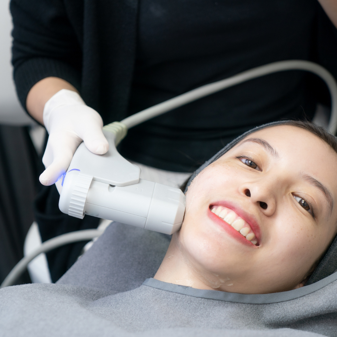 Smiling woman enjoys HIFU treatment on face